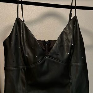 Small: Black faux leather dress with metal rhinestones at top. Looks better on!